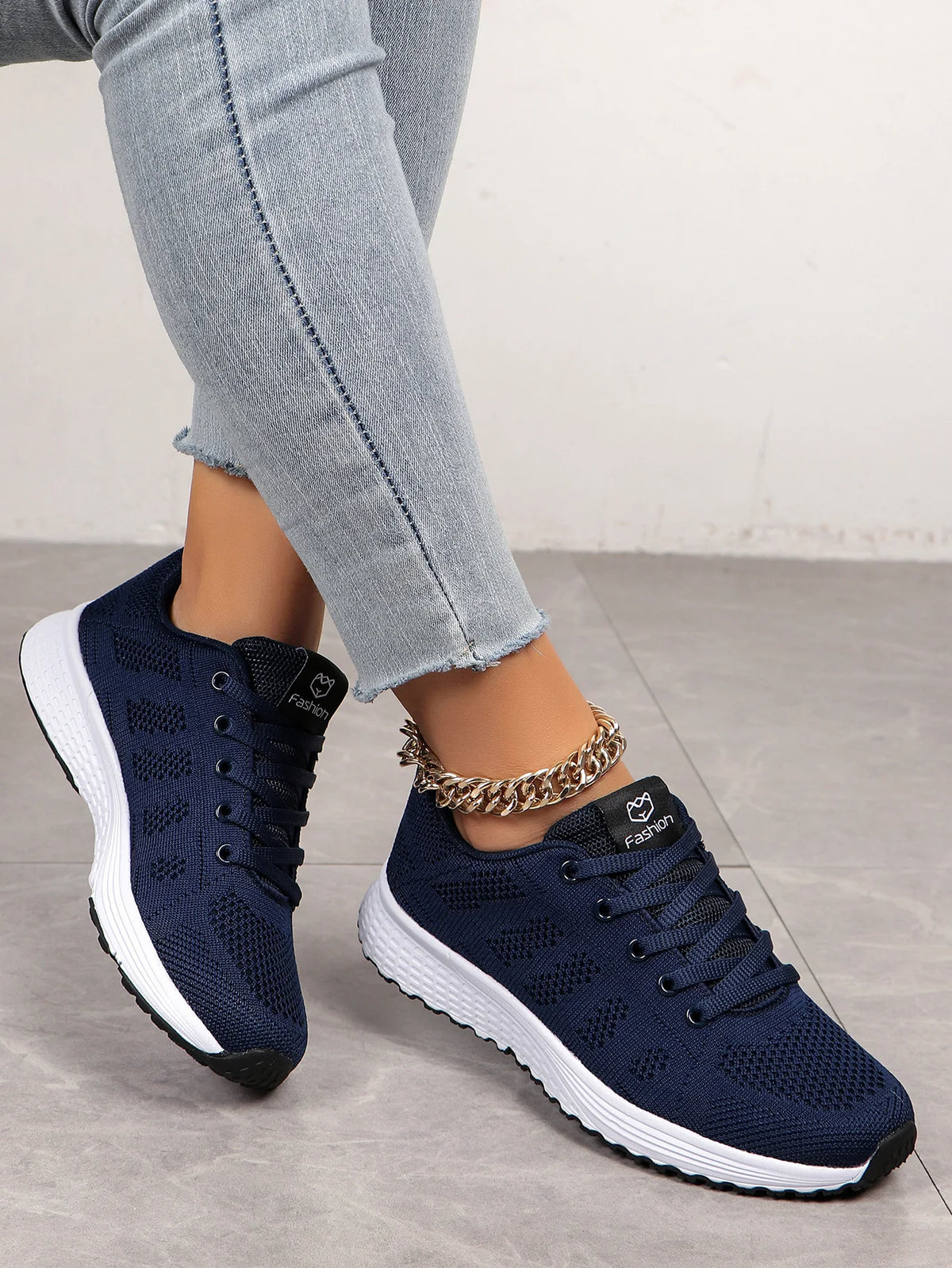 Women’s casual sports shoes with solid-colored fabric and front lacing, suitable for outdoor leisure wear.
