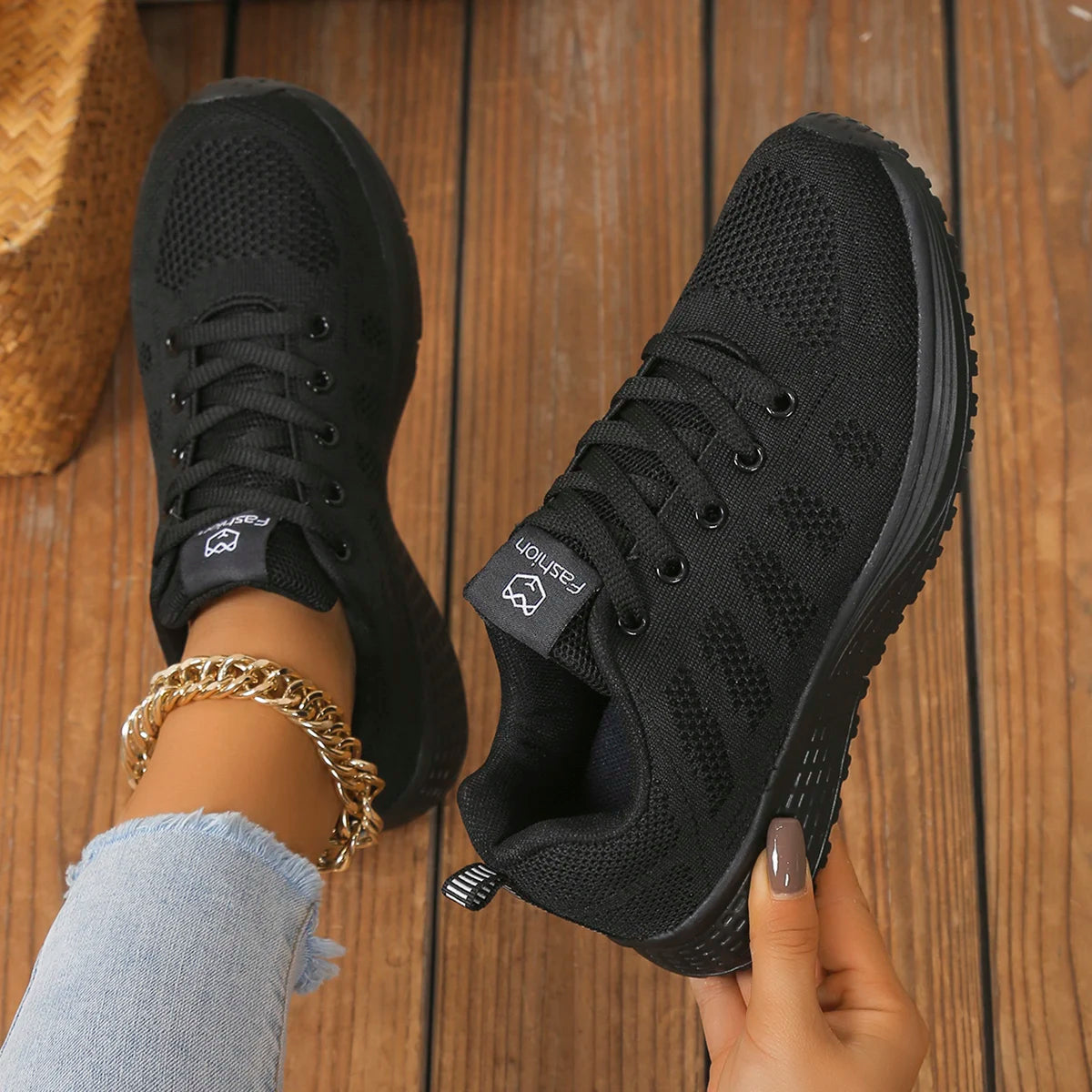 Women’s casual sports shoes with solid-colored fabric and front lacing, suitable for outdoor leisure wear.